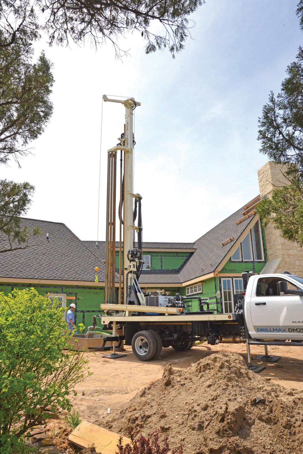 Simple operation and surprising power of DRILLMAX® DM250 water well drilling rigs make for fast production in tight spaces using 20-foot pipe for residential well installation.