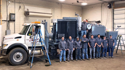 The East Coast Service Center team in front of a drill service rig refurbishment project..