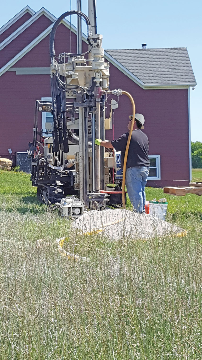 Installing geothermal loops in 6-inch diameter, 150-feet deep bores with a 7822DT using an industry-standard drill rod with a side-port swivel connected to rotary head. An external air compressor was used to clean cuttings out of boreholes and activate downhole hammer.